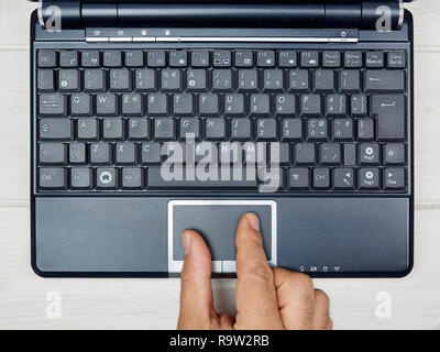 Top view male hand using touchpad on laptop keyboard Stock Photo