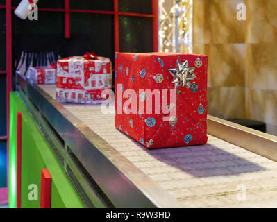 Gift boxes on conveyor belt xmas or christmas Stock Photo