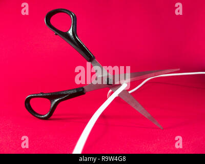cutting wire with scissors - tech, internet, information and communication styled concept, elegant visuals Stock Photo