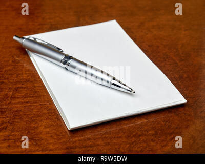 Pen on blank memo book on the table Stock Photo