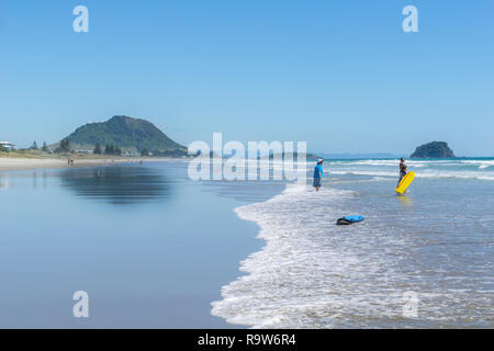 TAURANGA NEW ZEALAND - DECEMBER 18,2018; Long view beautiful ocean beach with people enjoying the weather and beach activities. Stock Photo