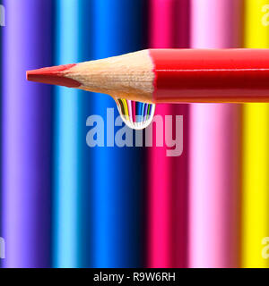 selective focus of vibrant coloured pencils  showing a water drop square with copy space and a blurred background ideal of text over lay Stock Photo