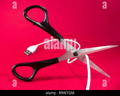 cutting wire with scissors - tech, internet, information and communication styled concept, elegant visuals Stock Photo