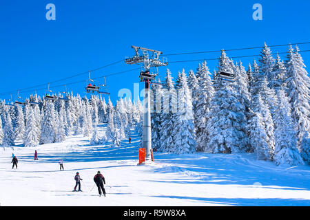 Kopaonik, Serbia - January 20, 2016: Ski resort Kopaonik, Serbia, ski slope, people on the ski lift, skiers and snowboarders on the slope Stock Photo