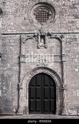 Door, circular window and stone work of the sixteenth century Azurara mother church, Vila do Conde, Portugal Stock Photo