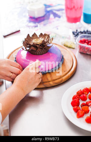 Process of decorating cake with mirror glaze Stock Photo