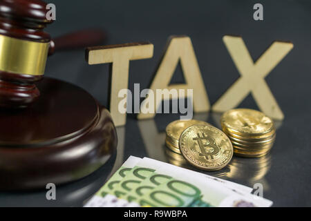 Gavel and cryptocurrency with hundred euro bills around it. Government regulation concept. Tax payment Stock Photo