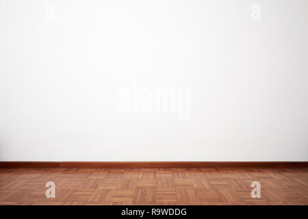 Empty room with brown wooden tiled floor and white blank wall Stock Photo