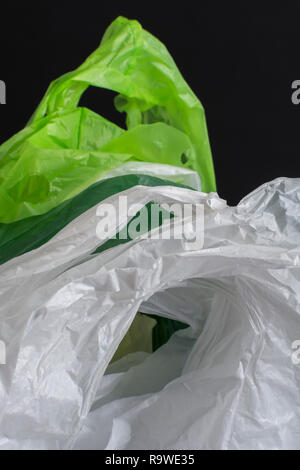 Multiple plastic shopping bags / carrier bags. Metaphor plastic bag tax, bag charge, war on plastic, plastic pollution UK. RM as identifiable colours. Stock Photo