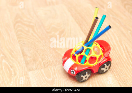 Collection of colorful markers, are in a toy children's machine. vertical view. copy space. place for text. children's theme. Stock Photo