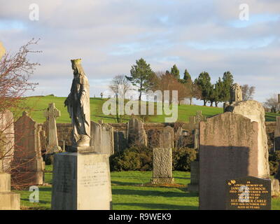 View of the gravestones and crosses on a bright winter's day at New Kilpatrick cemetery; a beautiful setting on Boclair Hill, Bearsden, Gasgow. Stock Photo