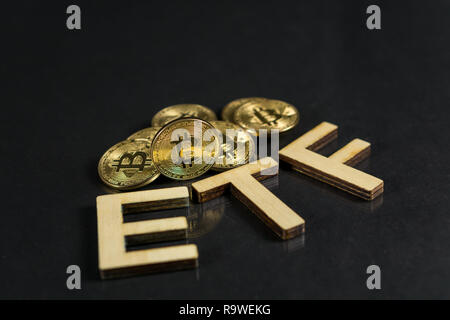 Bitcoin coin with ETF text Put on wooden floor, Concept Entering the Digital Money Fund. Stock Photo