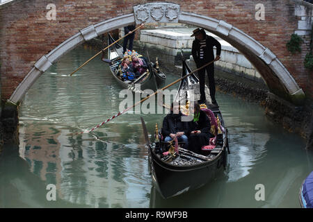 Couple attends the gondola tour in Venice, Italy. Stock Photo