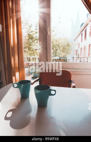 beautiful blue cups with tea on the table in the early morning Stock Photo