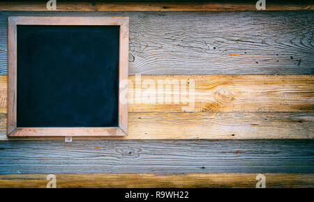 Vintage slate blank blackboard on wooden background Stock Photo