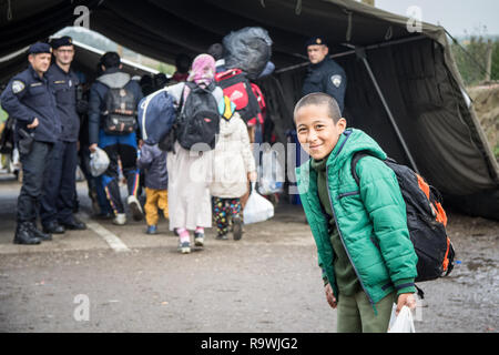 BERKASOVO, SERBIA - OCTOBER 17, 2015: Young refugee boy standing and waiting to cross the Croatia Serbia border, between the cities of Bapska and Berk Stock Photo