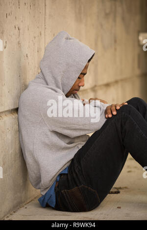Portarit of a African American young teen feeling depressed. Stock Photo