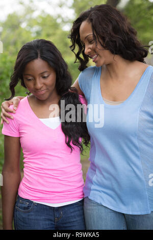 African mother embracing teen daughter and little boy son. African
