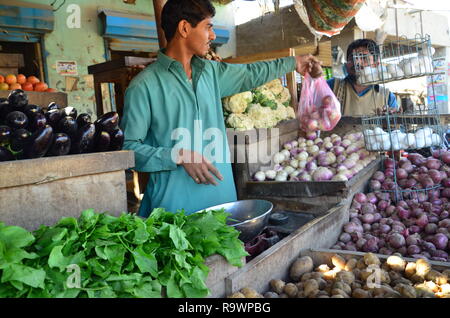 A fruits and vegetable seller at work in Sindh, Pakistan Stock Photo