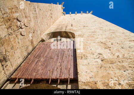 Ancient wooden rolling shutter gate with metal reinforcements at the entrance to the historical center of Cagliari in Italy Stock Photo