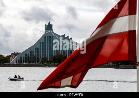 Latvian National Library. Cityscape from November 11 embankment with Latvian National Library, Latvia flag and motor boat in Riga. River Daugava and N Stock Photo