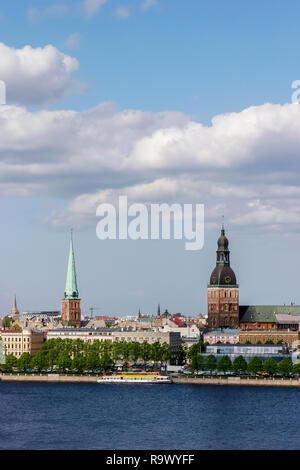 Riga, capital city of Latvia. View of St Peter's Church and St. Jacob's Cathedral. View of Old Riga with Daugava river in the foreground. City Riga wi Stock Photo