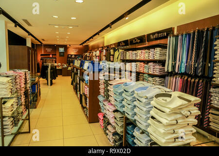 COLOMBO, SRI LANKA - SEPTEMBER 25, 2018:  Wide View of Menswear Clothes, Shirts, Trousers, Jackets with Shelves, Racks and Hangers inside a Fashion Re Stock Photo