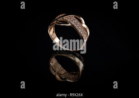 Precious gold ring with stones and reflection on glass Stock Photo