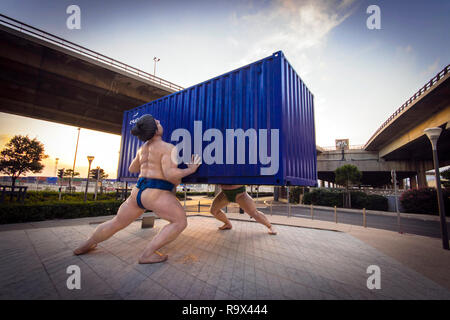 'takes two to tango' sculpture by Scottish artist David Mach of 2  chinese sumo wrestlers lifting a shipping container La Fondation CMA-CGM Marseilles Stock Photo