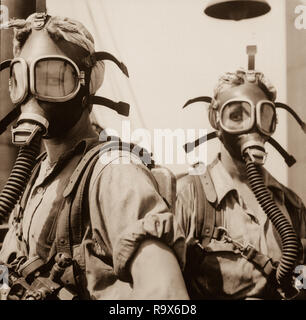 Like Girls from Mars Are These 'Top Women' at U.S. Steel's Gary, Indiana, Works. Their Job Is to Clean Up at Regular Intervals Around The Tops of Twelve Blast Furnaces. As A Safety Precaution, the Girls Wear Oxygen Masks., 1940 - 1945 Stock Photo