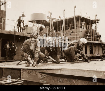 Chippers in a Shipyard Shipbuilding. Three Women Working, 1942 Stock Photo