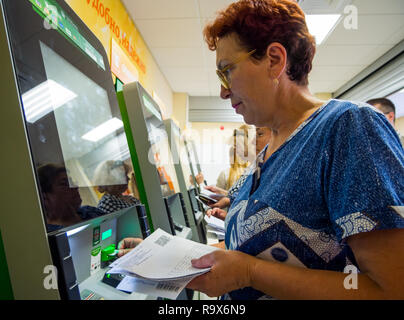 Voronezh, Russia - July 14, 2018: People pay for housing and communal services in self-service terminals Stock Photo