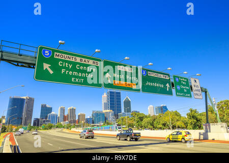 Perth, Western Australia - Jan 3, 2018: Perth highway road sign of Fremantle City Center, West Perth, Jondalup, Farmer Fwy and Charles St in Perth Downtown near John Oldham Park. Traffic urban scene.