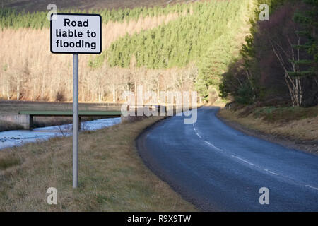 Road liable to flooding road safety sign by river in rural countryside Stock Photo