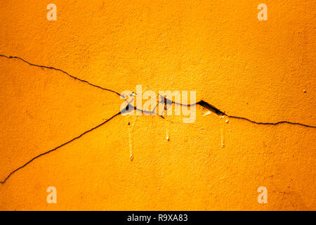 Abstract colorful cement wall texture and background. Grunge yellow painted on concrete wall. Stock Photo