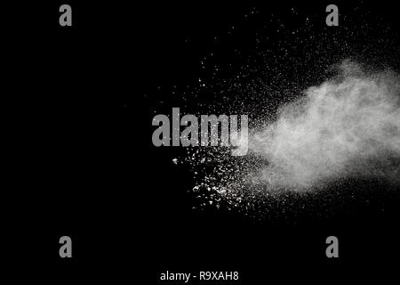White powder explosion on black background.Stopping the movement of white powder on dark background. Launched white powder splash. Stock Photo