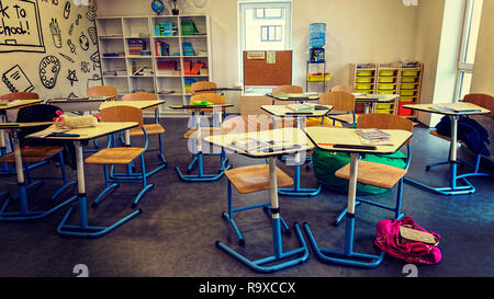 Interior of classroom in the modern school. School board, desks, textbooks. Back to school Stock Photo