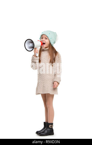 Little cute kid baby girl holding in hand and speaking in electronic gray megaphone isolated on white background. Kids childhood lifestyle concept. Copy space Stock Photo