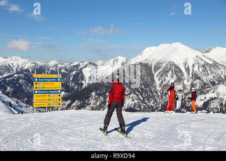 BAD HOFGASTEIN, AUSTRIA - MARCH 9, 2016: People analyze trail signs in Bad Hofgastein. It is part of Ski Amade, one of largest ski regions in Europe w Stock Photo