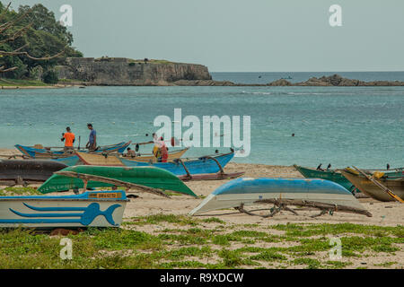 Colourful fishing boats on the beach of  Dutch Bay in Trincomalee, Sri Lanka Stock Photo