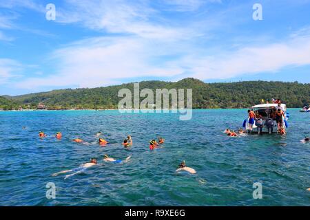 KO PHI PHI, THAILAND - DECEMBER 20, 2013: Tourists snorkel in open sea offshore near Ko Phi Phi island in Thailand. 26.7 million people visited Thaila Stock Photo