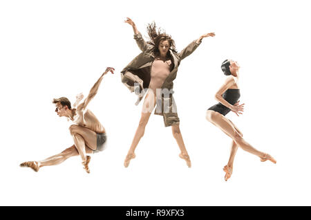 Beautiful slim young modern jazz contemporary style ballet dancers in silhouette wearing beige long cloak isolated on a white studio background Stock Photo