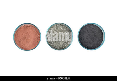 Three colored chemical powder in a glass on white background, top view Stock Photo