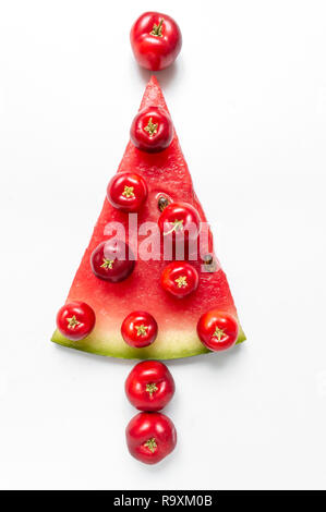 Christmas tree shape made out of fruits - acerola cherry and watermelon Stock Photo