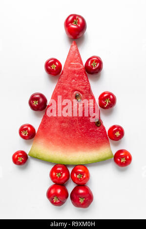 Christmas tree shape made out of fruits - acerola cherry and watermelon Stock Photo