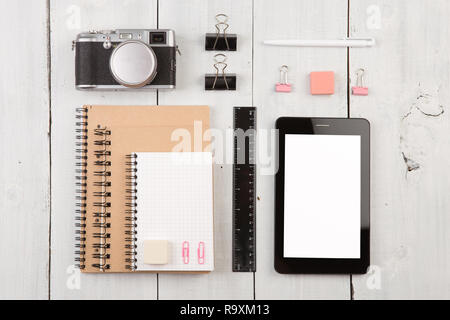 workplace with tablet pc, notepads, camera, ruler and pen. Top view Stock Photo