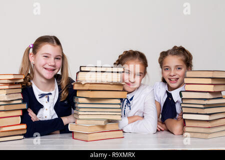 three girls at school in the classroom for books knowledge Stock Photo
