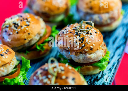 Homemade small hamburgers with fresh vegetables and meat patties Stock Photo