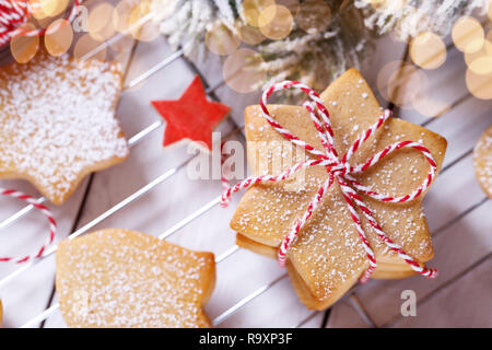 A stack of Christmas gingerbread shortbread cookies on white wooden table Stock Photo