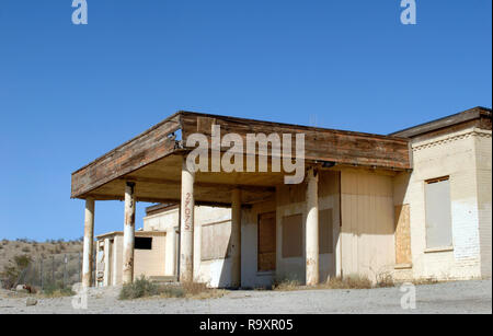 A boarded-up commercial building stands along the National Trails Highway, also known as historic Route 66, in Helendale, California. Stock Photo